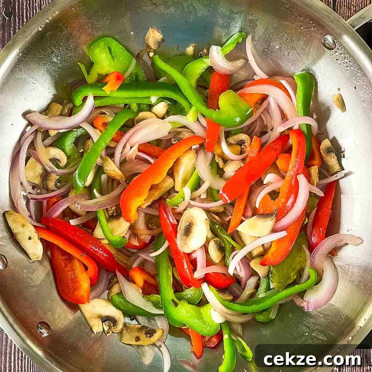 The sauteed vegetables in a large skillet.