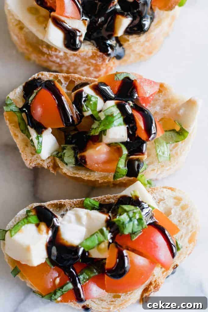Overhead view of caprese bruschetta drizzled with a balsamic glaze. 