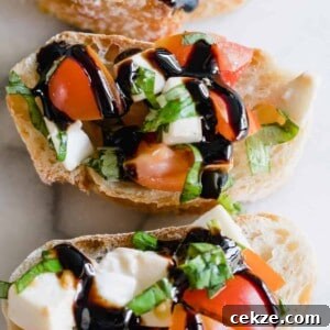 Overhead view of caprese bruschetta drizzled with a balsamic glaze.