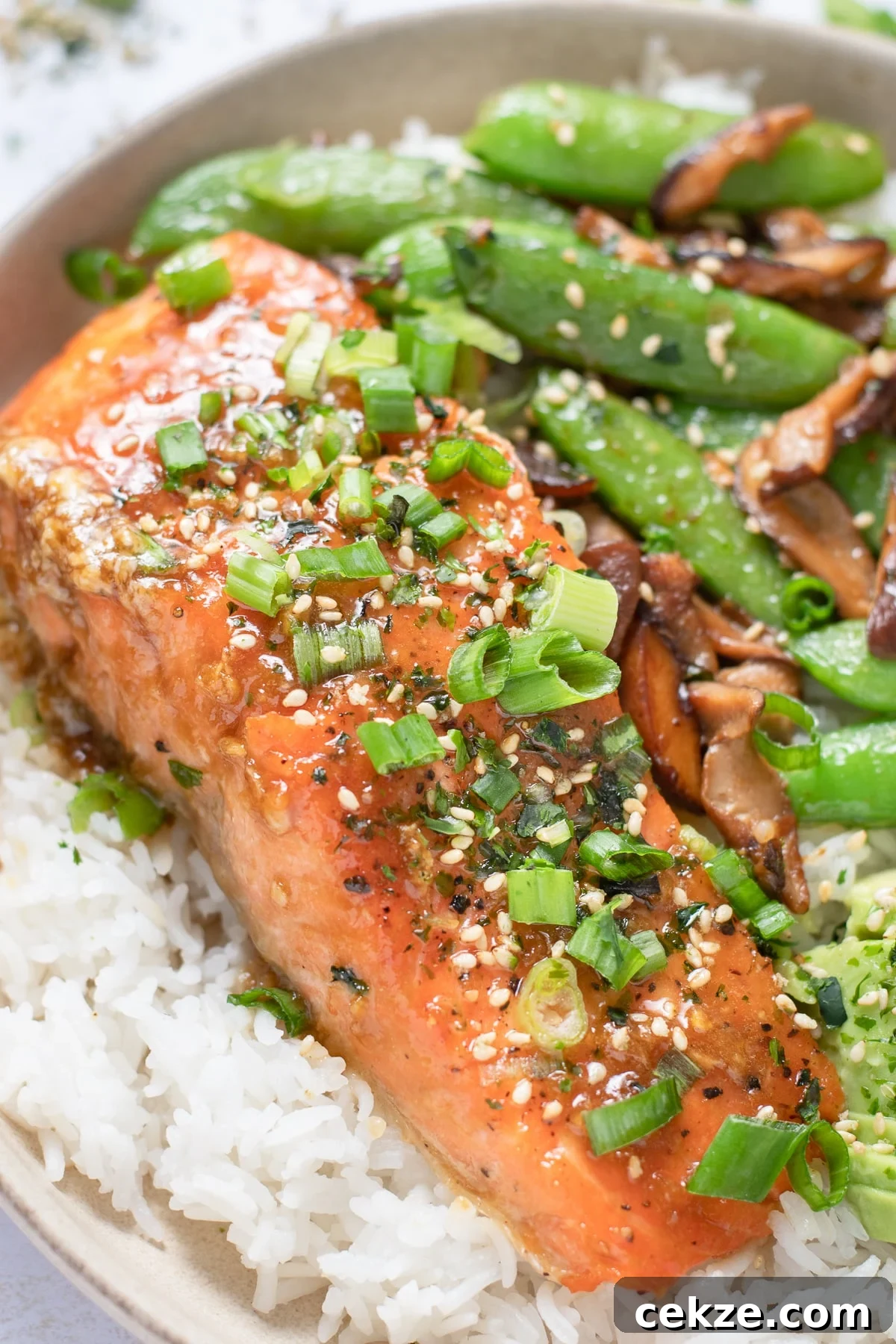 Miso butter salmon with sautéed shiitake mushrooms, snap peas and jasmine rice