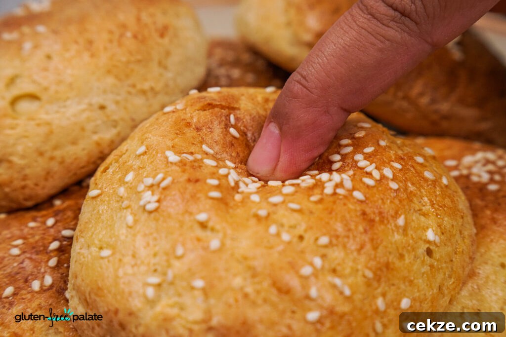 A finger pressed into the top of a gluten-free hamburger bun. Photo by Gluten-Free Palate.
