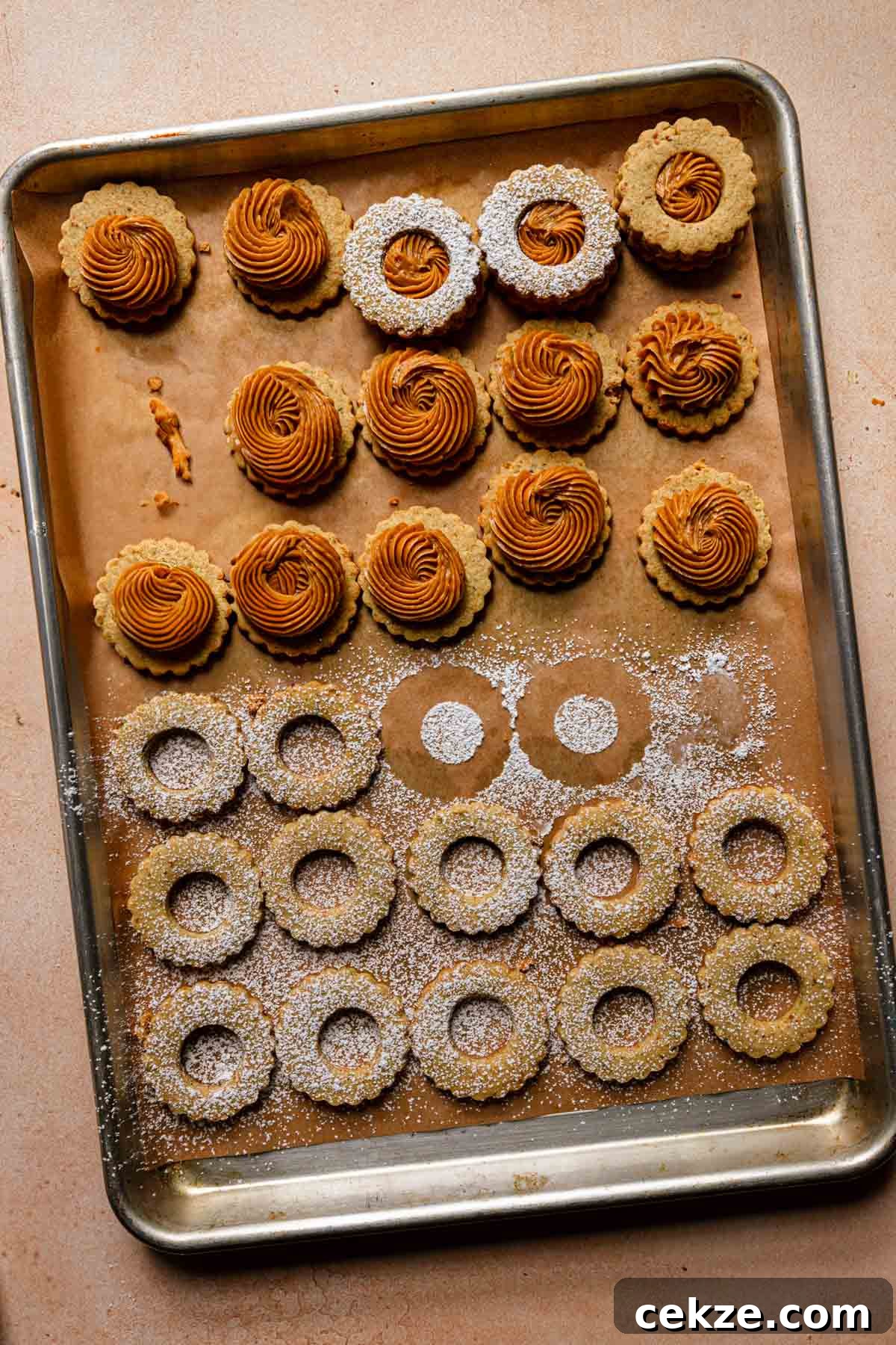 A pan with cookies topped with pistachio caramel cream.
