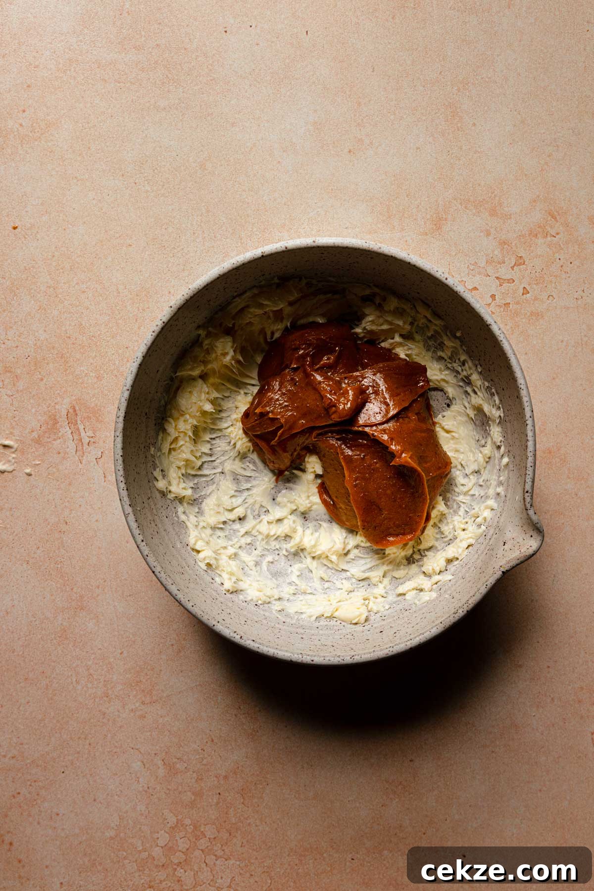 A large bowl with whipped butter and pistachio caramel.