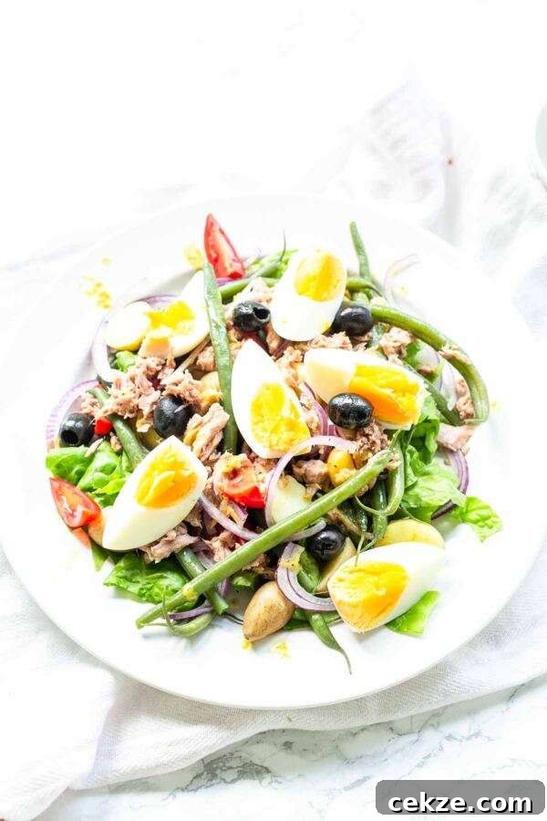 Classic Niçoise Salad Recipe: Tuna, Eggs & Mediterranean Veggies 8 A classic salad recipe this salad nicoise fits perfectly on your bistro menu. Serve for lunch or as a side dish with dinner. A great summer salad with summer vegetables, eggs and tuna. Super quick and easy so the ultimate fast-food recipe.
