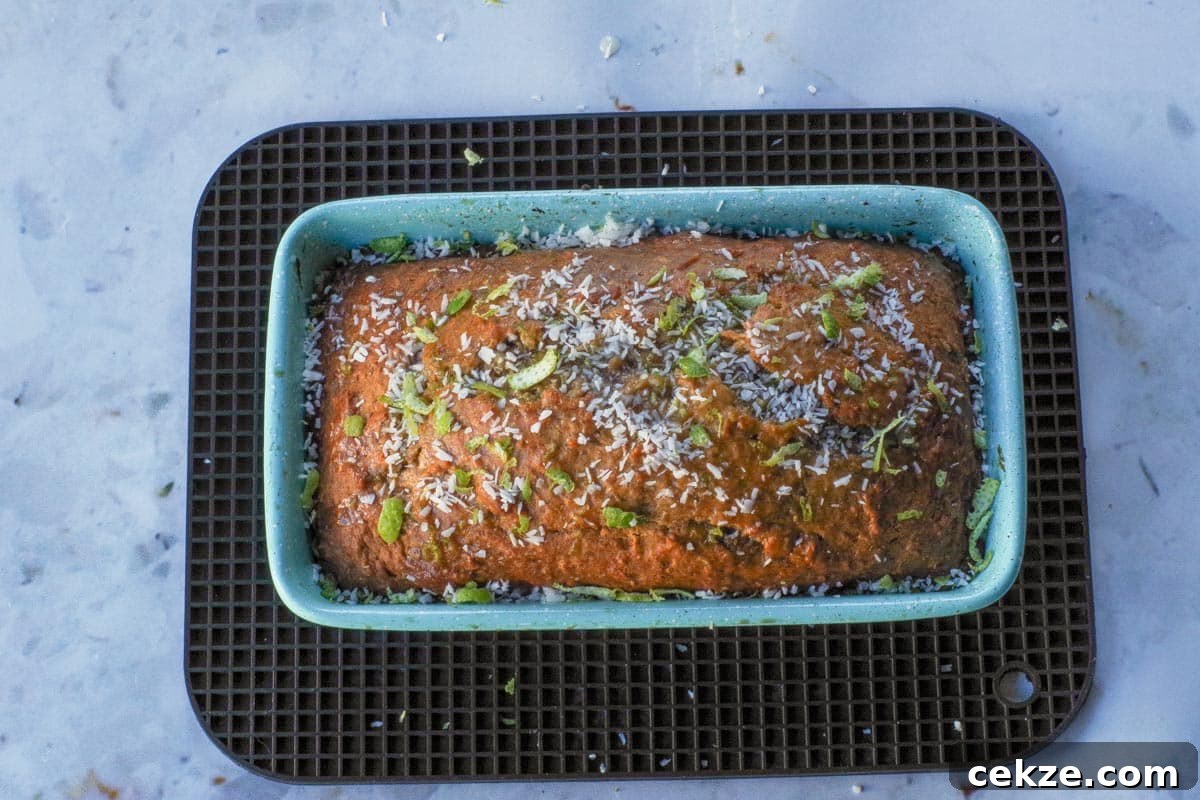 Tropical Banana Bread with Lime Glaze Recipe 14 Tropical Banana Bread garnished with coconut and lime in loaf pan.