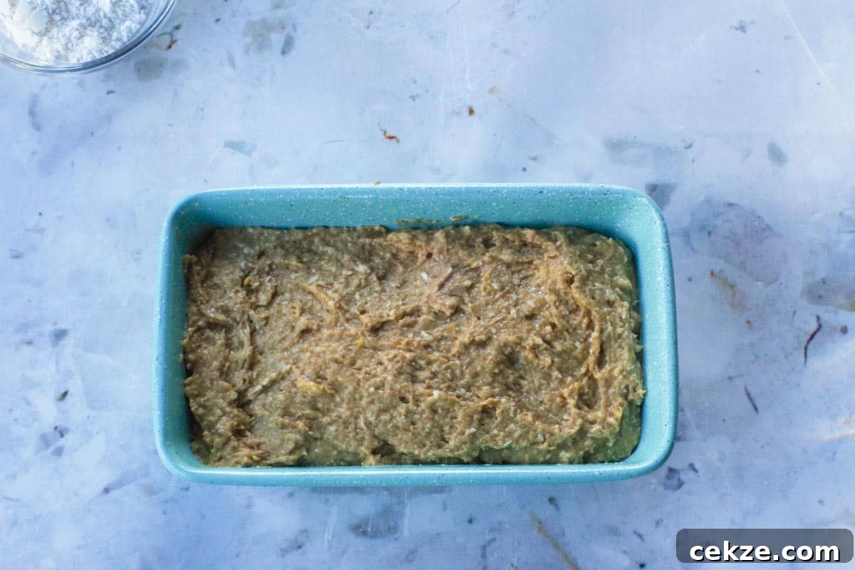 Tropical Banana Bread with Lime Glaze Recipe 10 Tropical Banana Bread batter poured into a blue loaf pan.