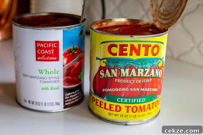 Classic Homemade Pizza Sauce Recipe for Perfect Pies 6 two different brands of canned whole tomatoes on a white countertop.