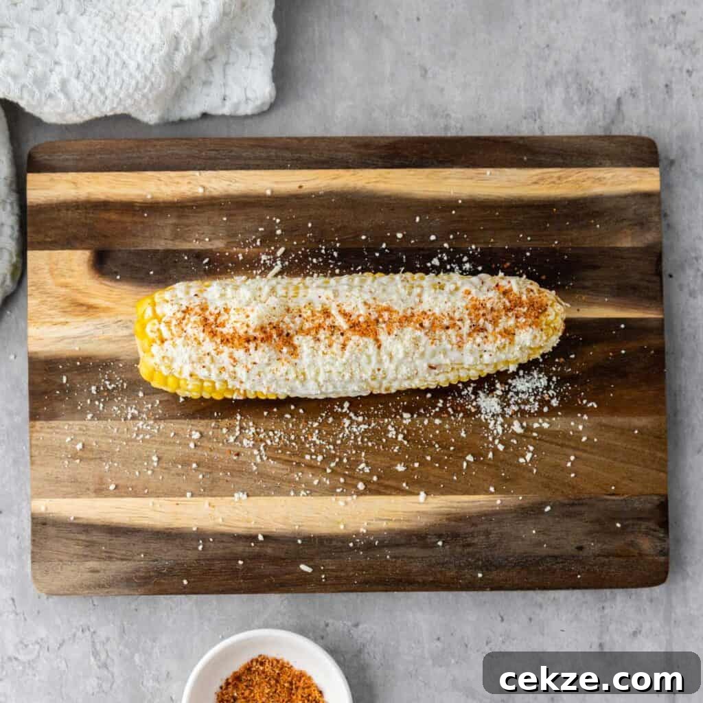 Authentic Elotes Recipe: Mexican Street Corn with Cotija & Lime 5 corn cob with mayonnaise, cotija cheese, and chili powder