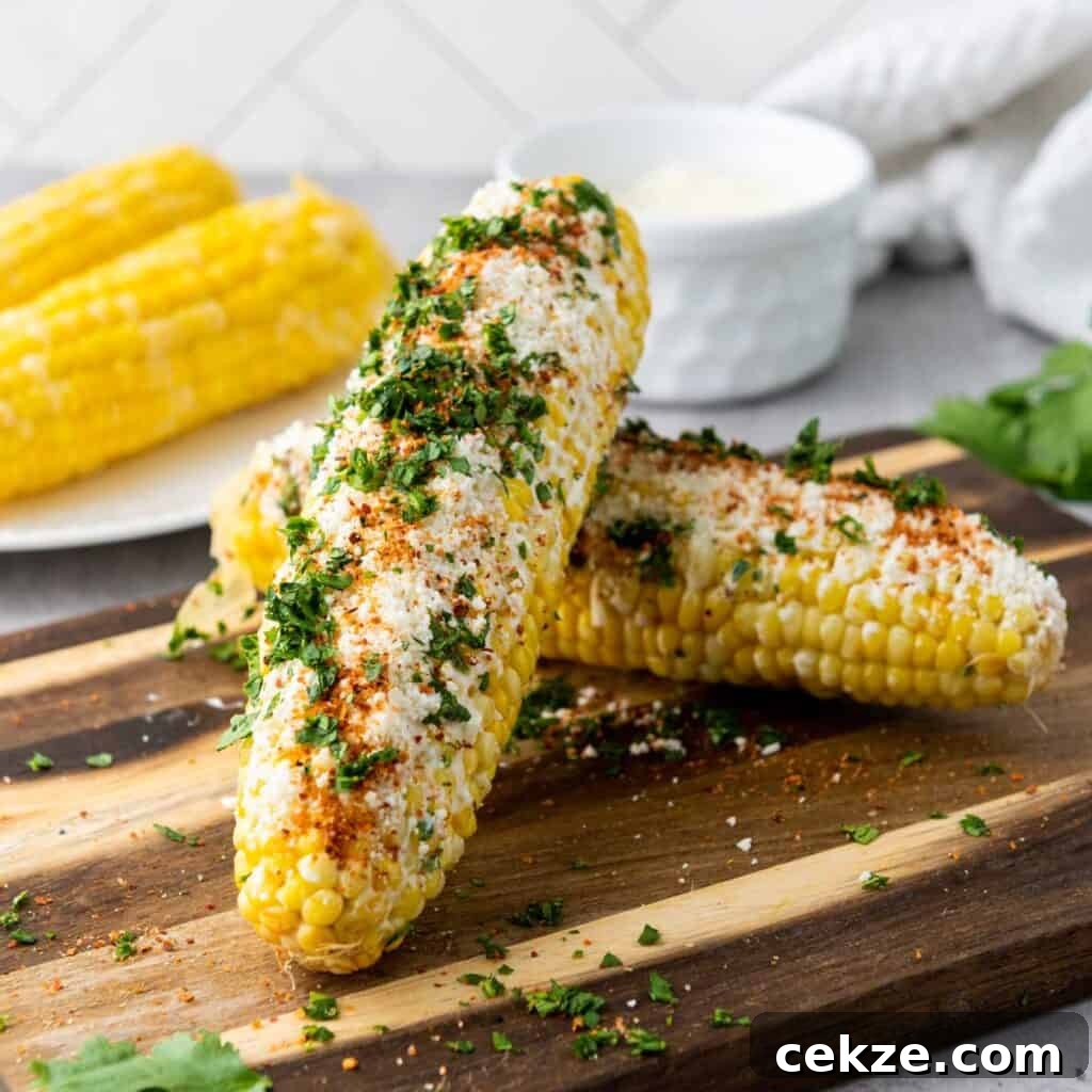 Authentic Elotes Recipe: Mexican Street Corn with Cotija & Lime 6 elotes Mexican street corn on wooden cutting board
