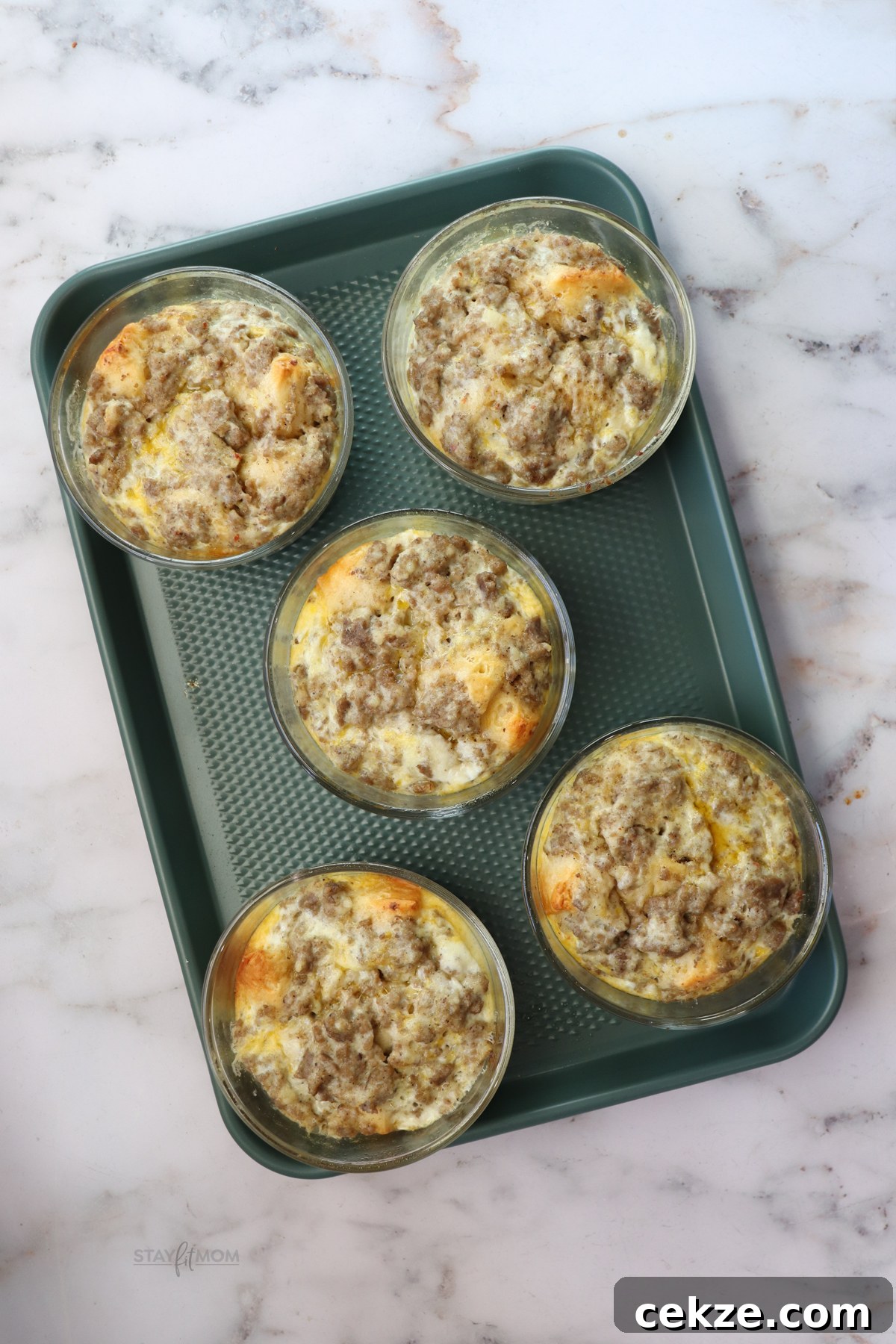 Meal prepped biscuit and gravy breakfast bowls ready for the week in oven-safe containers.