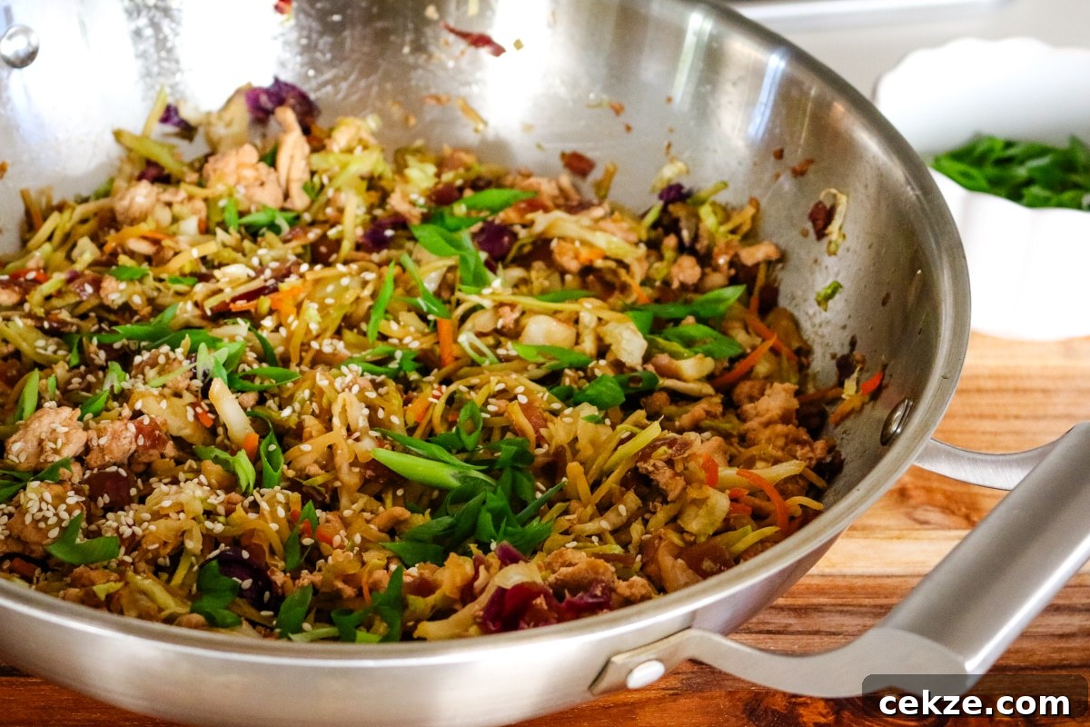 Keto Egg Roll in a Bowl Recipe: Quick Low-Carb Stir-Fry 2 egg roll in a bowl in a work on a wooden board.