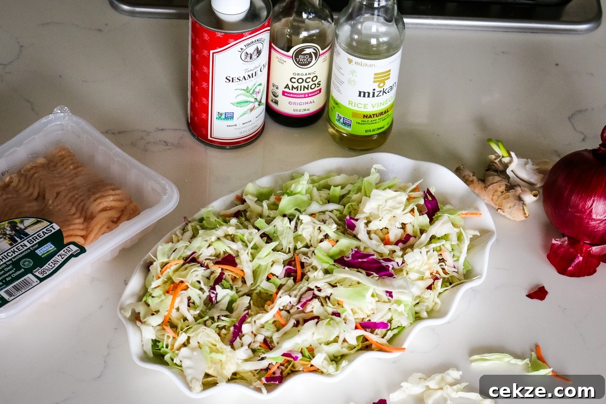 Keto Egg Roll in a Bowl Recipe: Quick Low-Carb Stir-Fry 3 ingredients for egg roll in a bowl with rice vinegar, sesame oil, cabbage, and ground chicken.