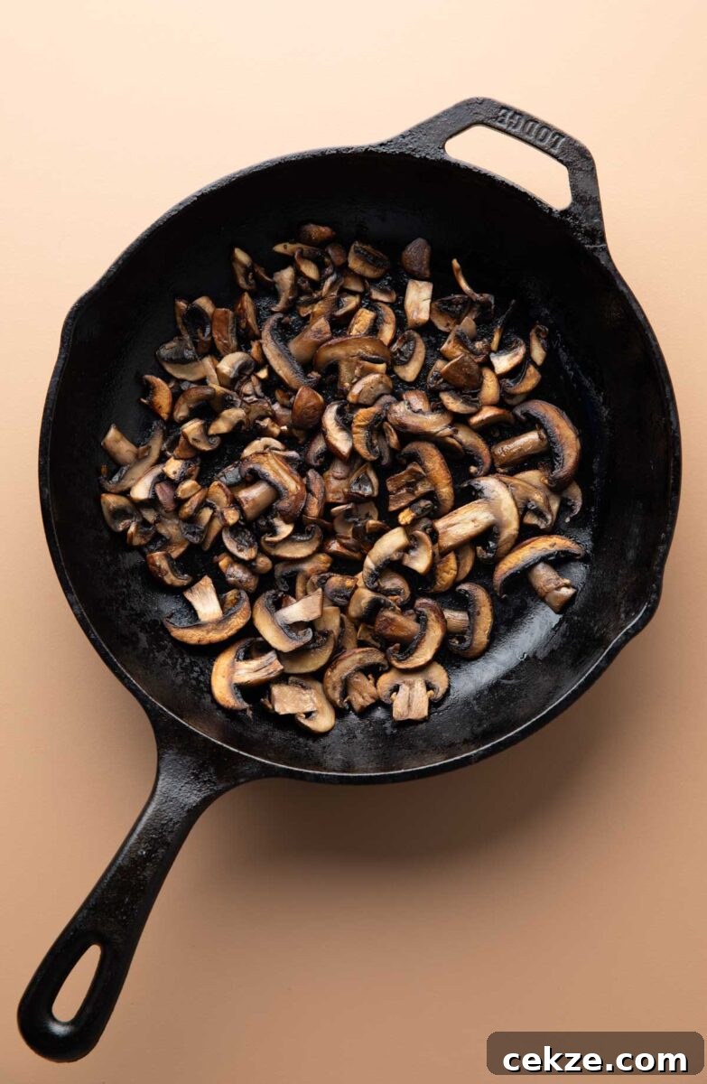 sliced sauteed mushrooms in a cast iron skillet