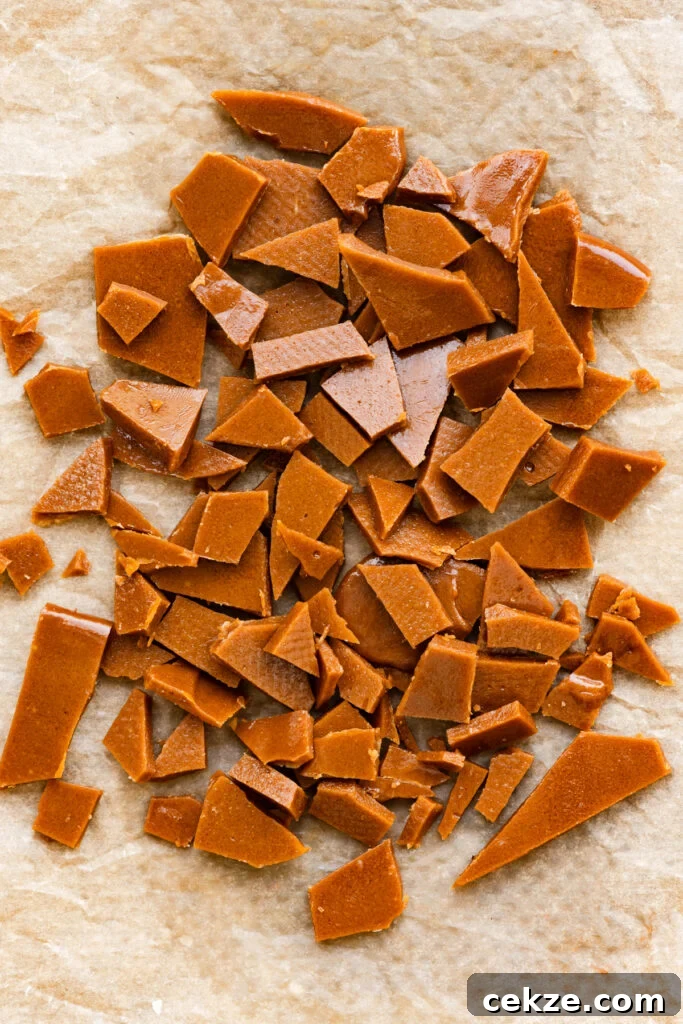 Brown Sugar Toffee Cookies Recipe — Chewy Caramelized Treats 4 Homemade toffee chopped into pieces on a silicone mat.