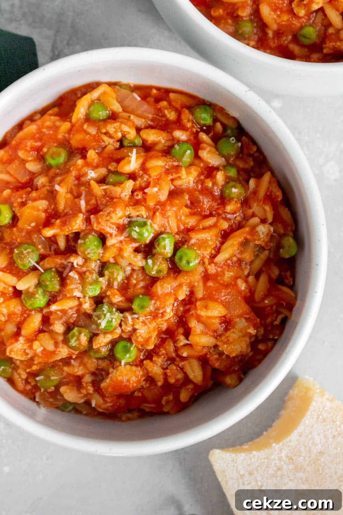 One-Pot Turkey and Pea Orzo Skillet Recipe 8 Close up of a bowl of one pot orzo with turkey and peas.