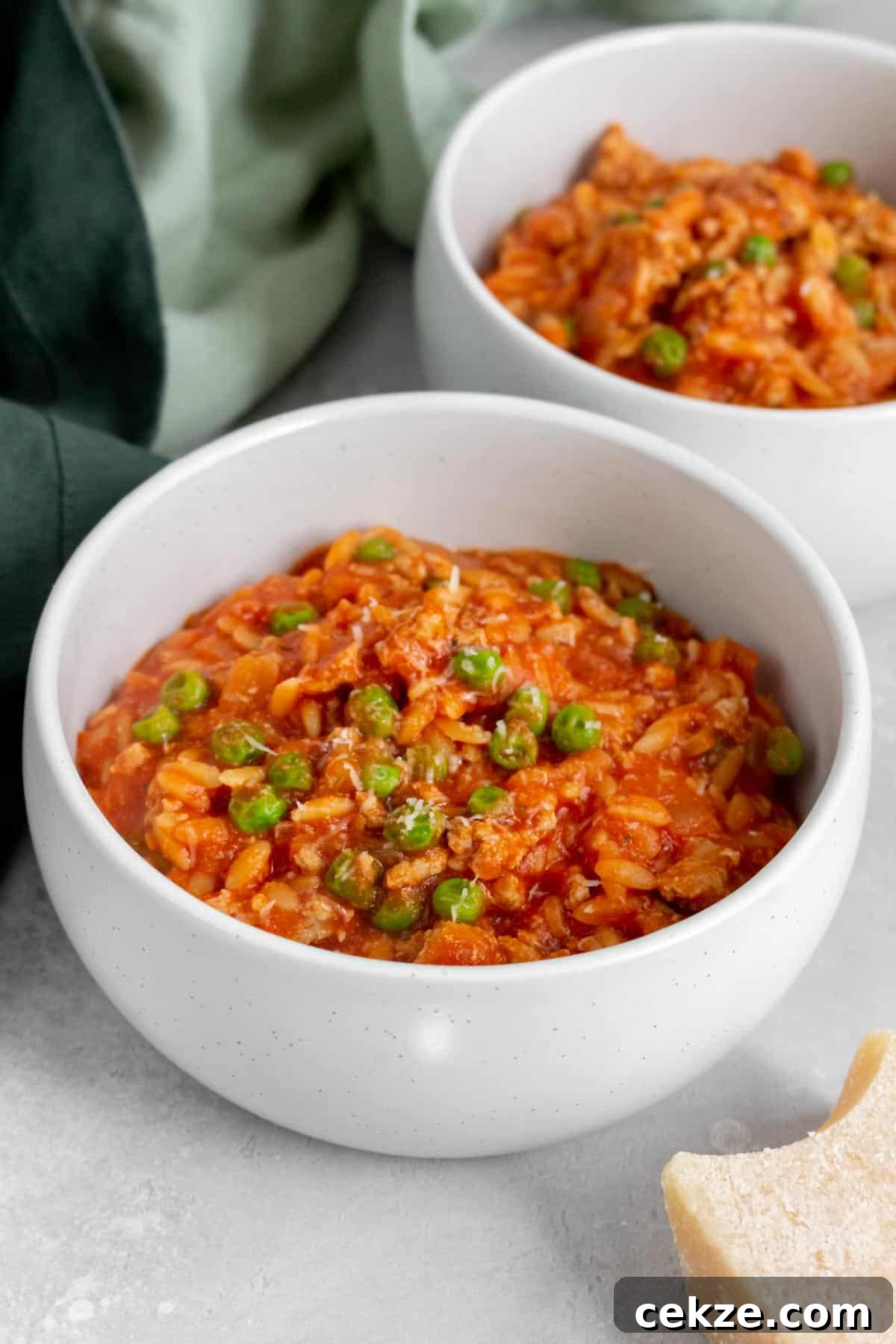 One-Pot Turkey and Pea Orzo Skillet Recipe 9 Angled view of a bowl of one pot orzo with turkey and peas.