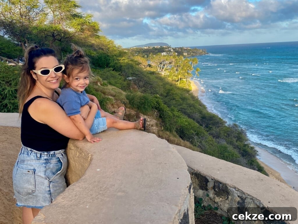 Scenic Oʻahu Lookouts You Can Drive To 3 Two people posing by the Amelia Earhart Marker at one of the Diamond Head Overlooks on Oʻahu.