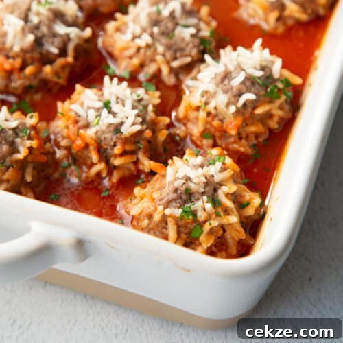 porcupine meatballs in a white casserole dish.