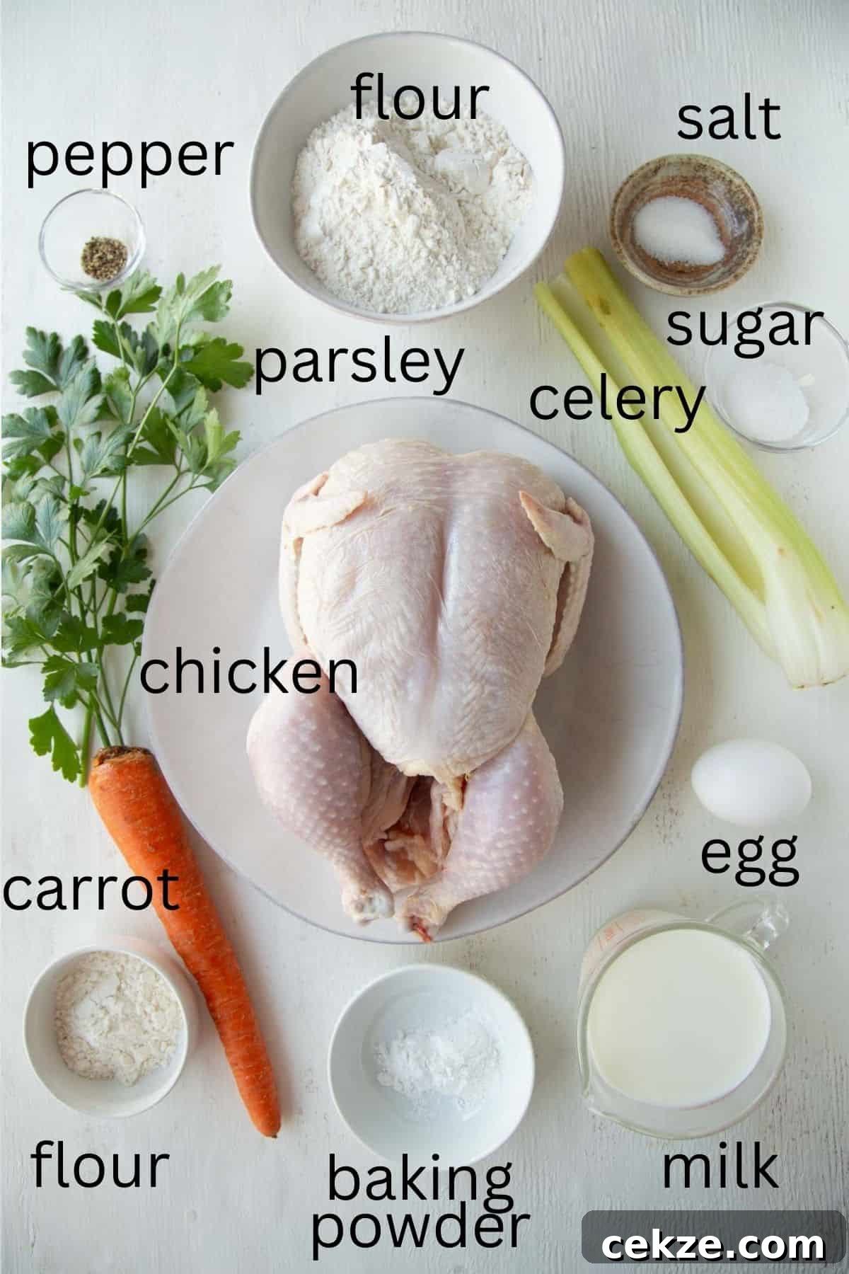 chicken, carrot, celery, parsley, flour, and other ingredients for chicken and dumplings.