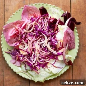 Red Salad with Radicchio, Citrus, Honey and Thyme Vinaigrette on a plate.