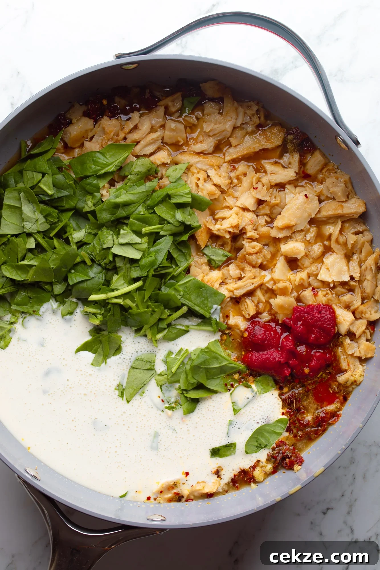 overhead view of the ingredients for vegan marry me pasta sauce in a large skillet.