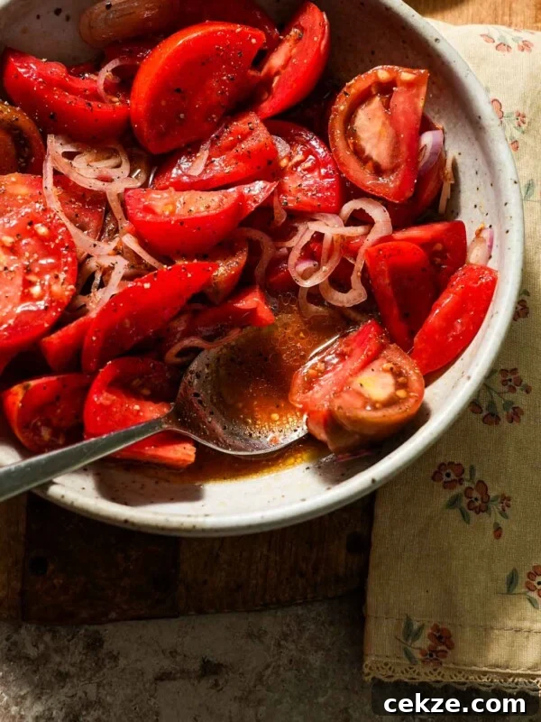 Roasted Hot Honey Brussels Sprouts (5-Ingredient Recipe) 8 A bowl of marinated tomatoes with a spoon of juices.