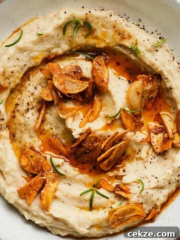 Roasted Hot Honey Brussels Sprouts (5-Ingredient Recipe) 9 Creamy white bean dip with crispy garlic and fresh rosemary garnish.