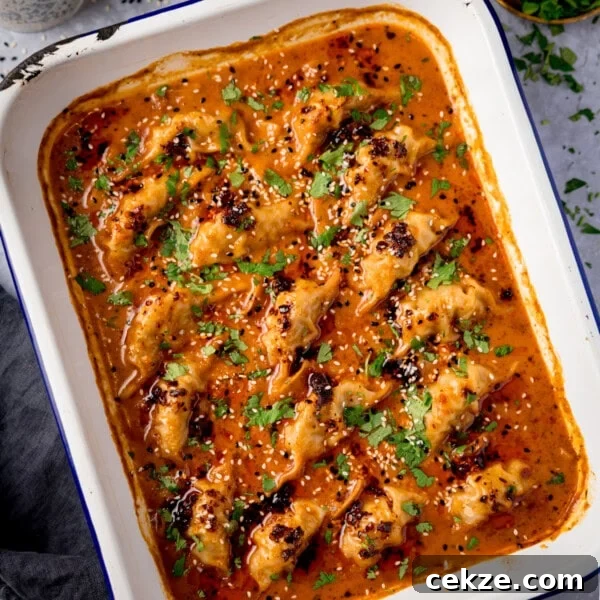 Curry-Roasted Chicken with Crispy Skin and Aromatic Spices 15 Baked dumplings in a rectangular dish topped with a spicy orange curry sauce.