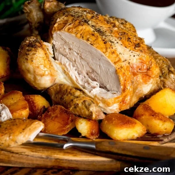 Curry-Roasted Chicken with Crispy Skin and Aromatic Spices 7 Sliced roast chicken on a board with potatoes and gravy.