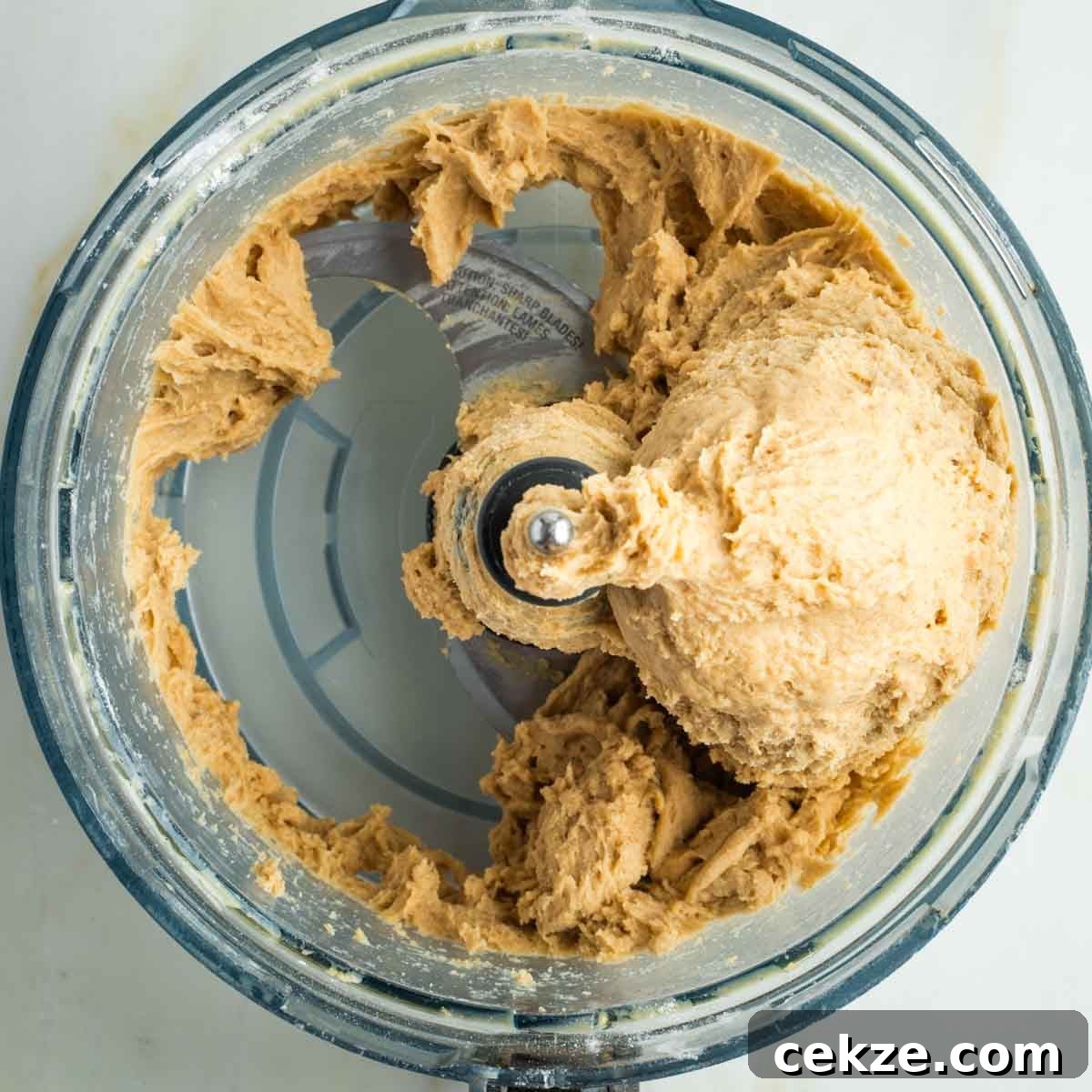 Sweet Round Challah Recipe: Soft, Shiny Braided Dinner Bread 14 Bread dough, still sticking to the sides of a food processor bowl.