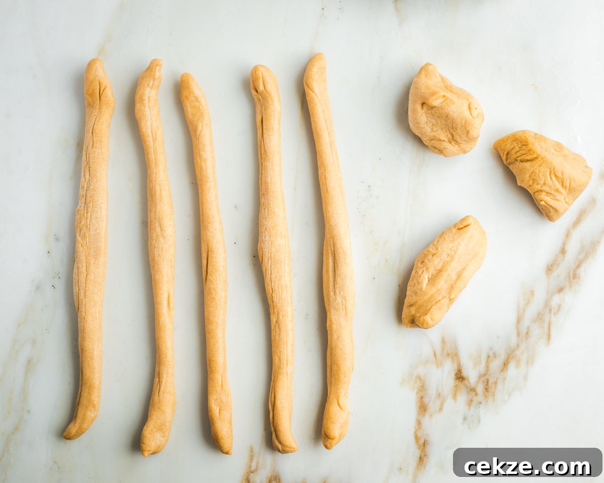 Sweet Round Challah Recipe: Soft, Shiny Braided Dinner Bread 21 Three pieces of dough and 5 strands of rolled out rope like lengths of dough.
