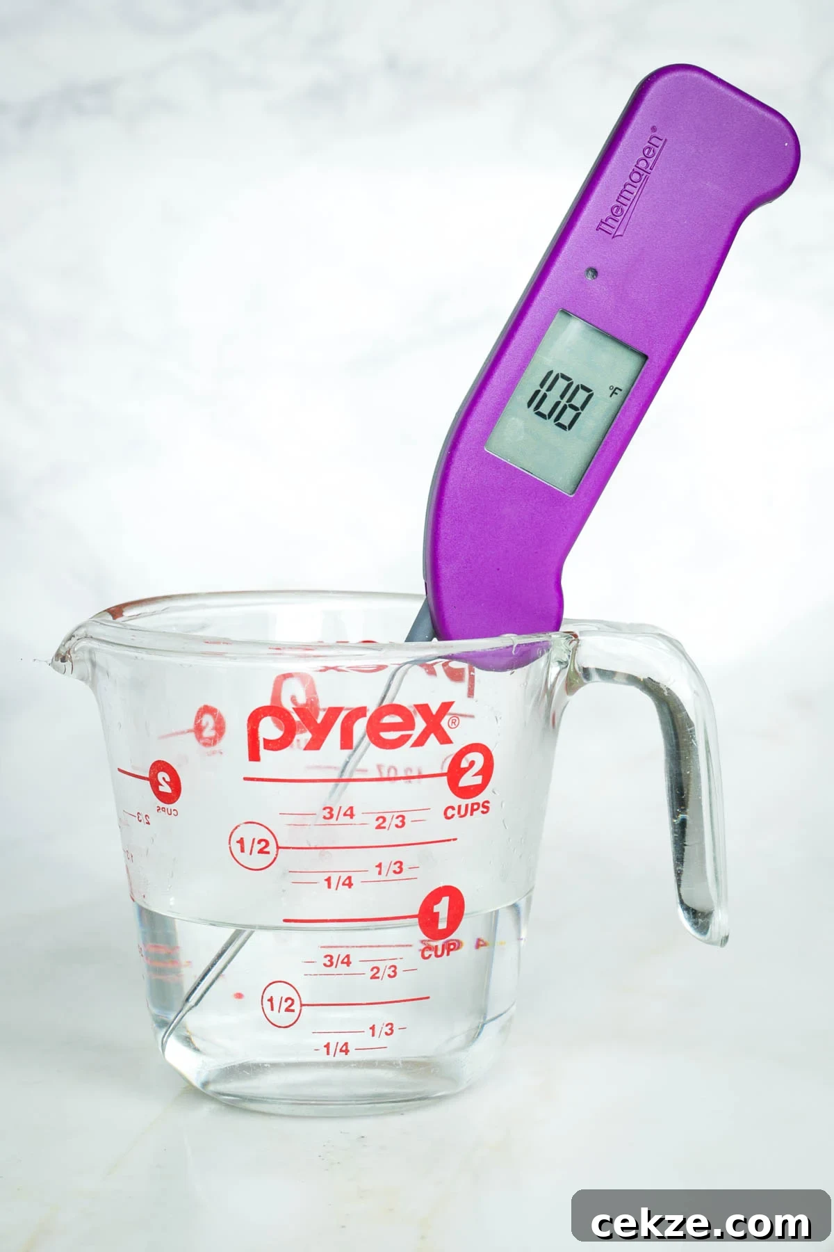 Sweet Round Challah Recipe: Soft, Shiny Braided Dinner Bread 4 Thermometer showing 108 degrees in a glass cup of water.