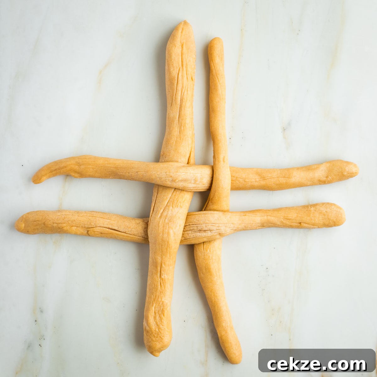 Sweet Round Challah Recipe: Soft, Shiny Braided Dinner Bread 27 4 strands of dough, 2 horizontal, 2 vertical in a criss cross pattern.