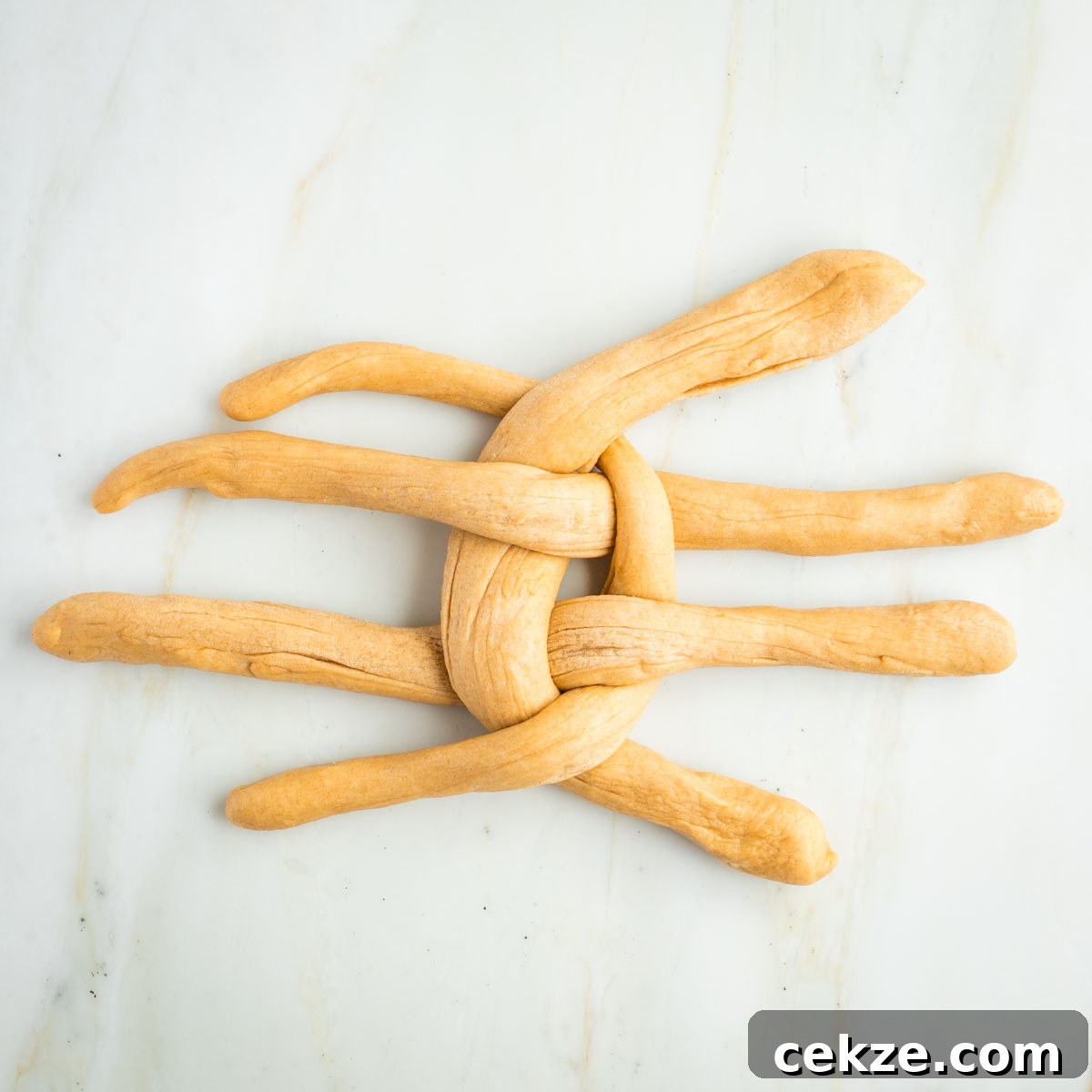 Sweet Round Challah Recipe: Soft, Shiny Braided Dinner Bread 28 Long ropes of dough, woven into a criss cross pattern.