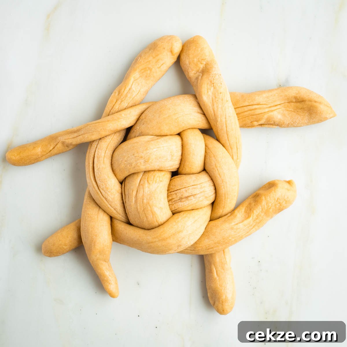 Sweet Round Challah Recipe: Soft, Shiny Braided Dinner Bread 30 Weaving ropes of dough over and under in a circular pattern.