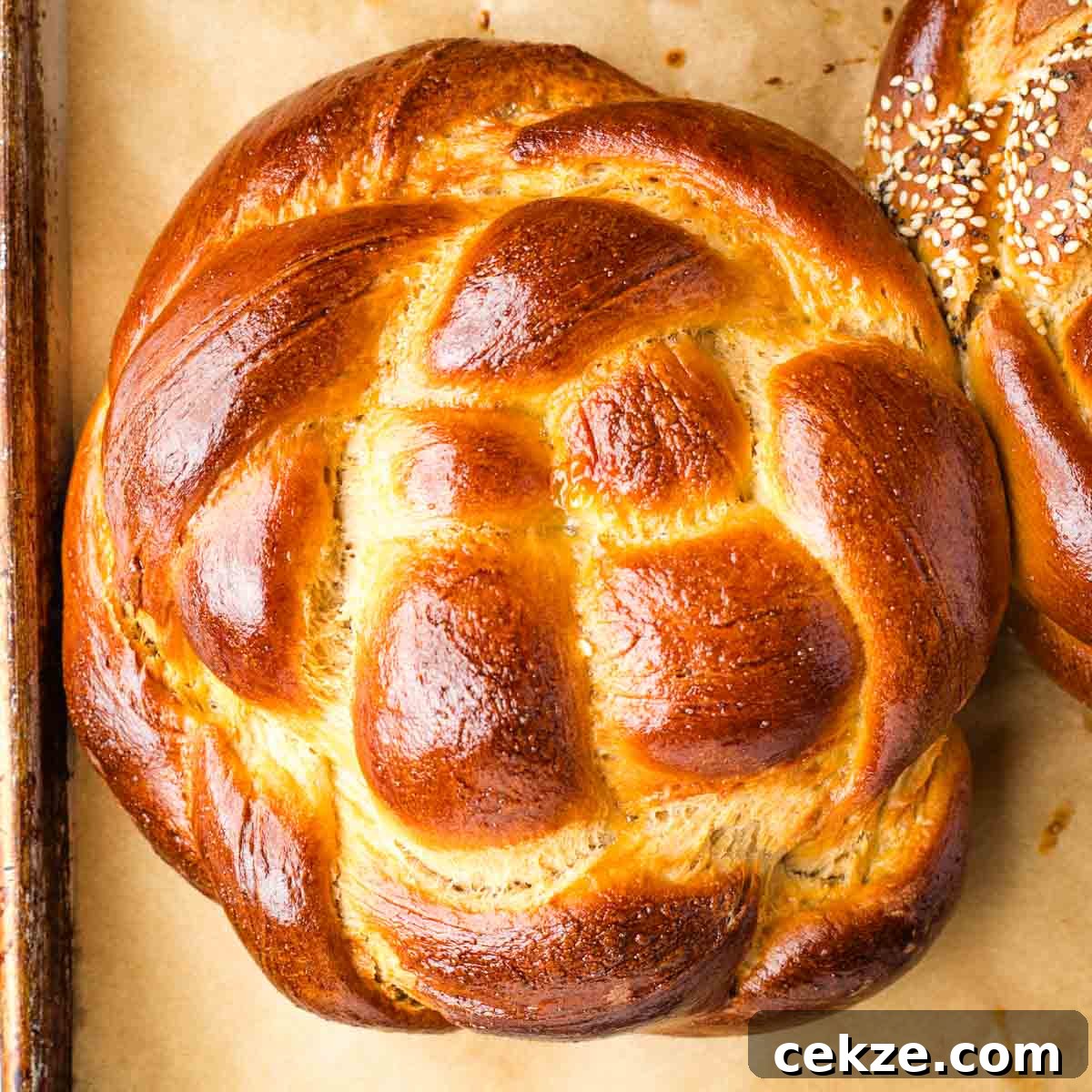Sweet Round Challah Recipe: Soft, Shiny Braided Dinner Bread 35 Golden brown, round braided loaf of challah.