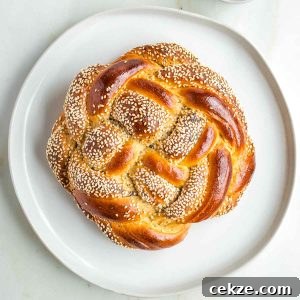 Sweet Round Challah Recipe: Soft, Shiny Braided Dinner Bread 38 Round, braided challah, some strands with sesame and poppy seeds.