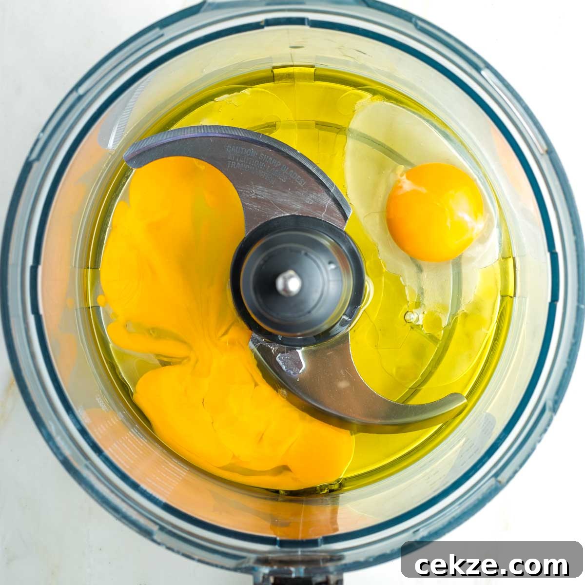 Sweet Round Challah Recipe: Soft, Shiny Braided Dinner Bread 8 Eggs and oil in the bowl of a food processor.