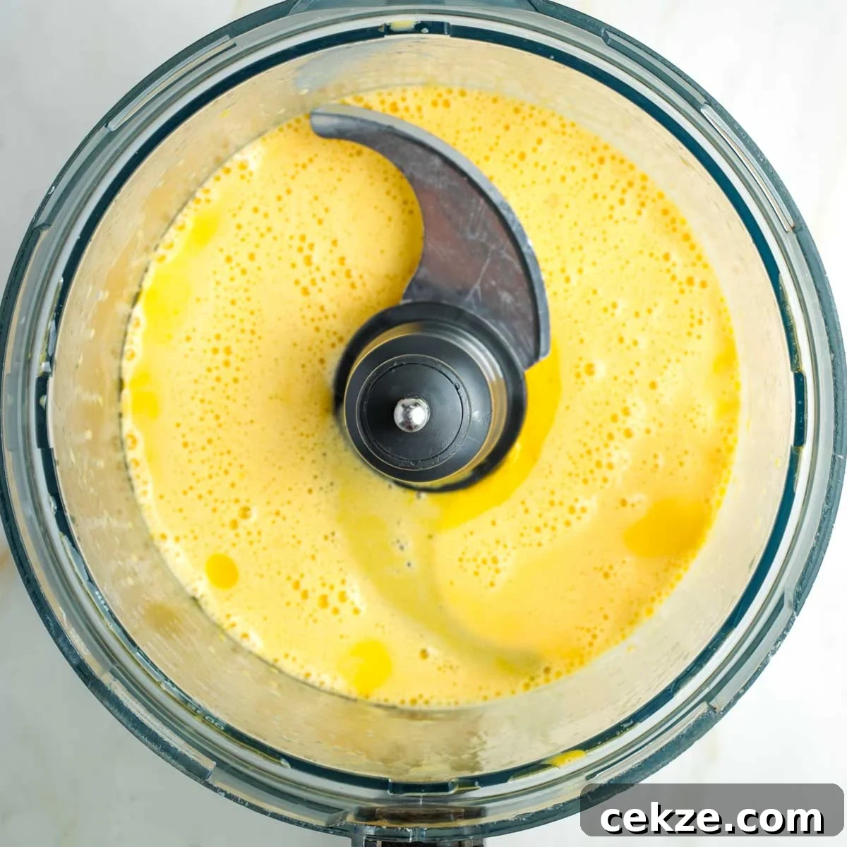 Sweet Round Challah Recipe: Soft, Shiny Braided Dinner Bread 9 Food processor bowl with whipped eggs and oil.