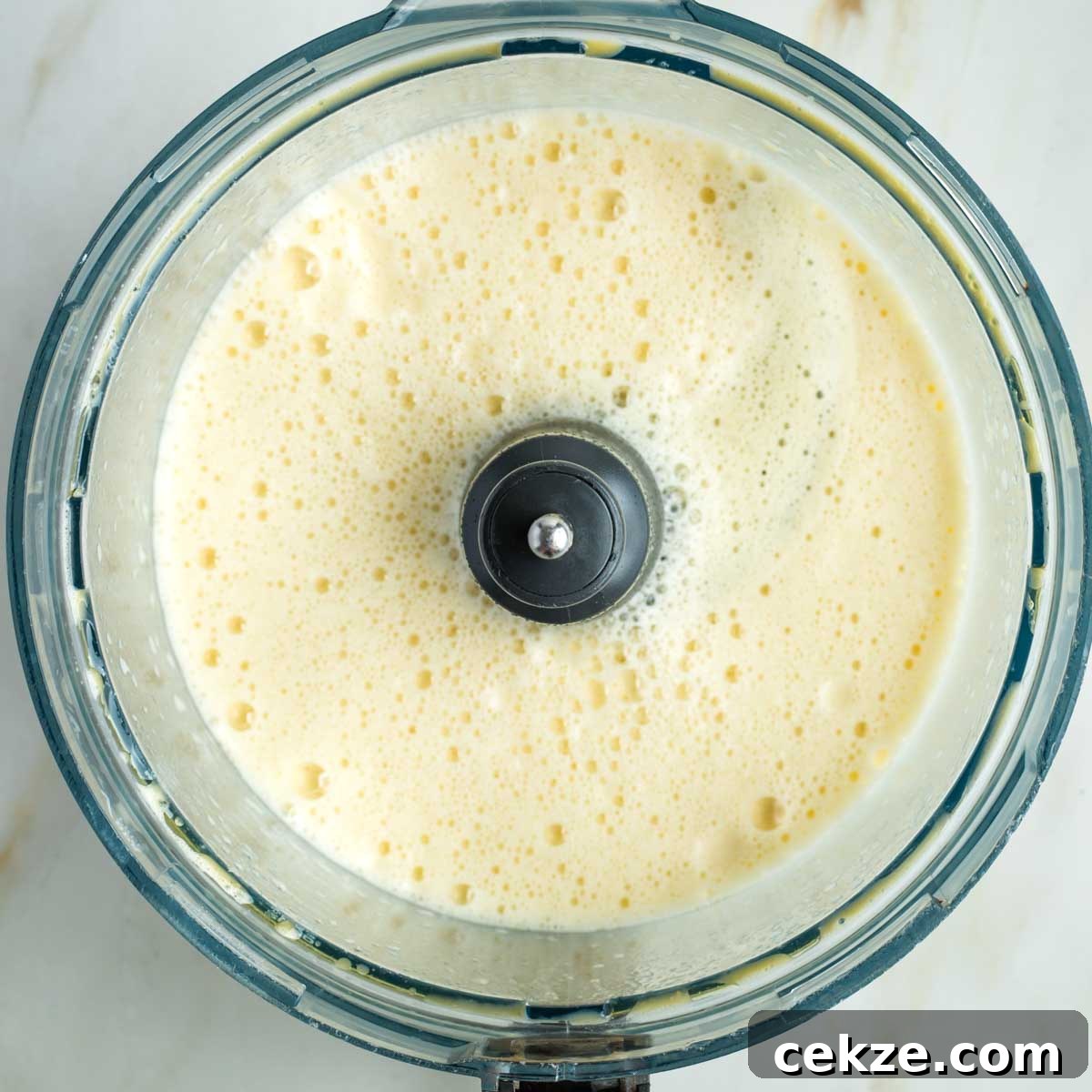 Sweet Round Challah Recipe: Soft, Shiny Braided Dinner Bread 10 Frothy eggs, oil and yeast mixture in the bowl of a food processor.