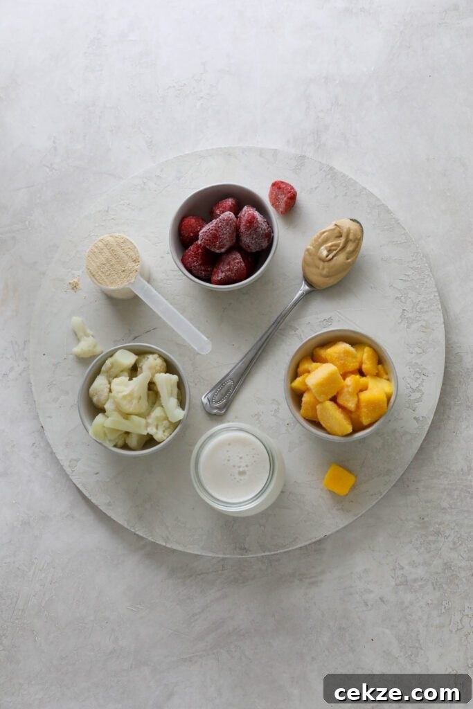 Strawberry Mango Smoothie Bowl Recipe for Creamy Tropical Breakfast 3 Strawberry Mango Smoothie Bowl ingredients on white board