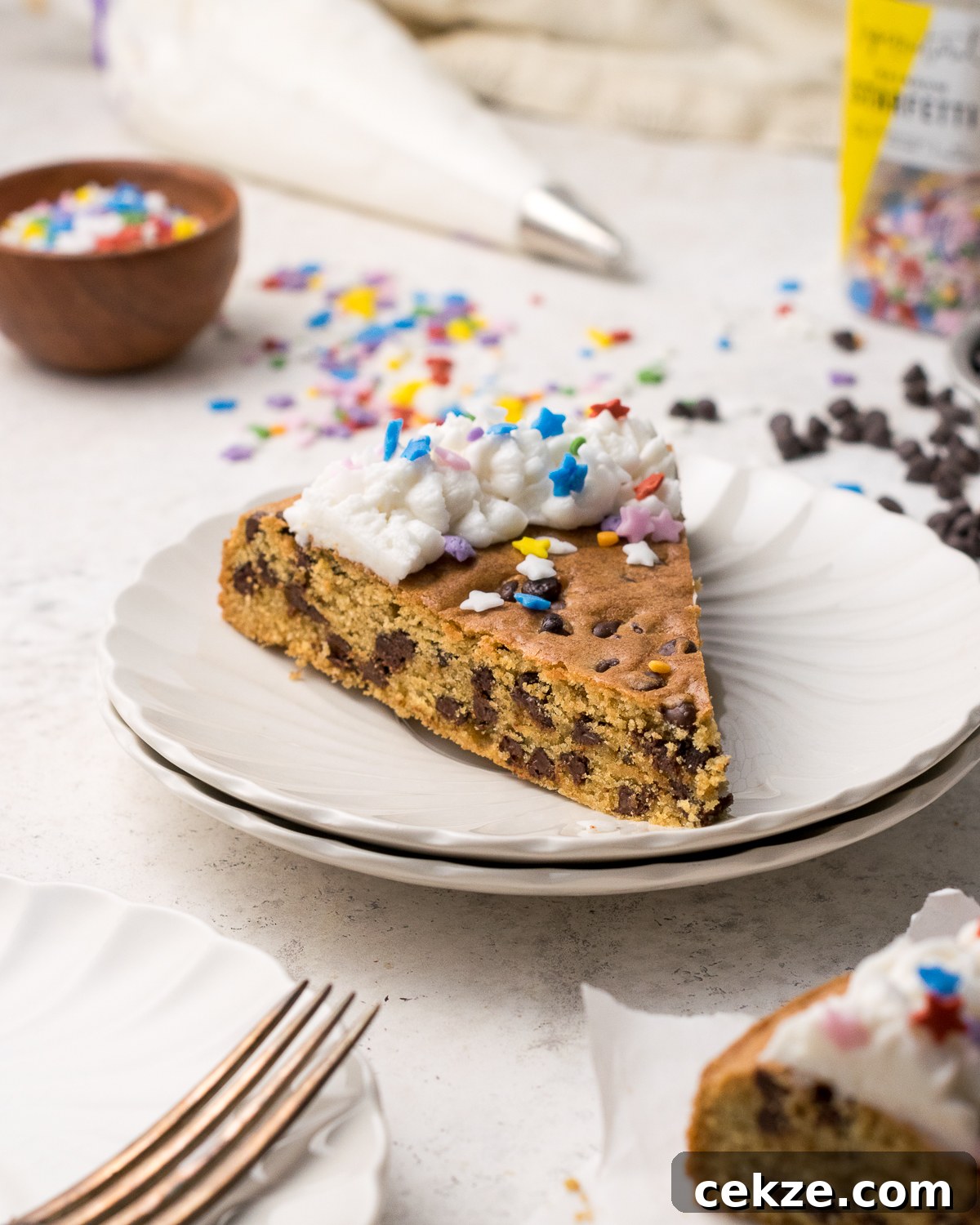 Slice of gluten free cookie cake on white plate.