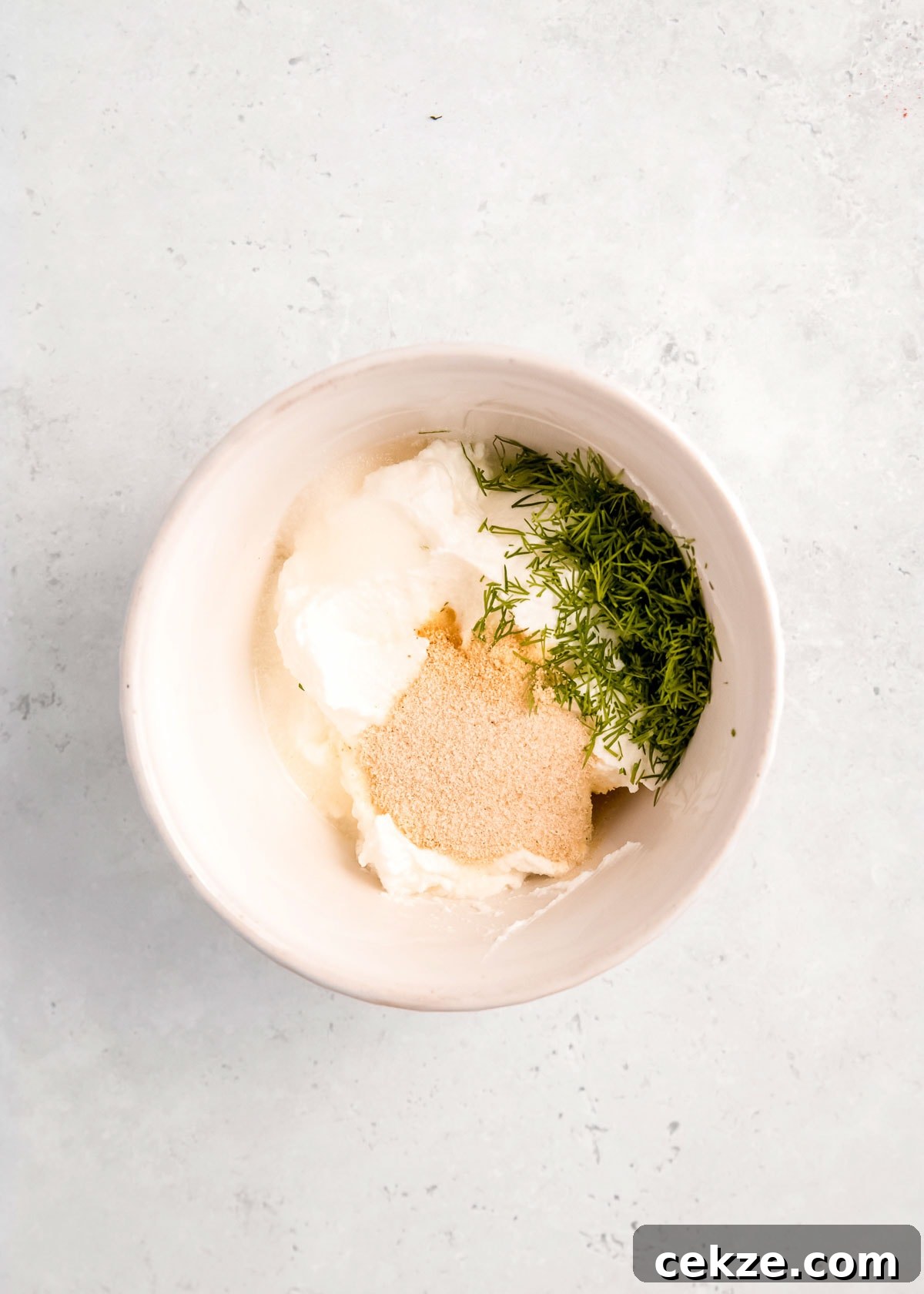 yogurt sauce ingredients in a white bowl
