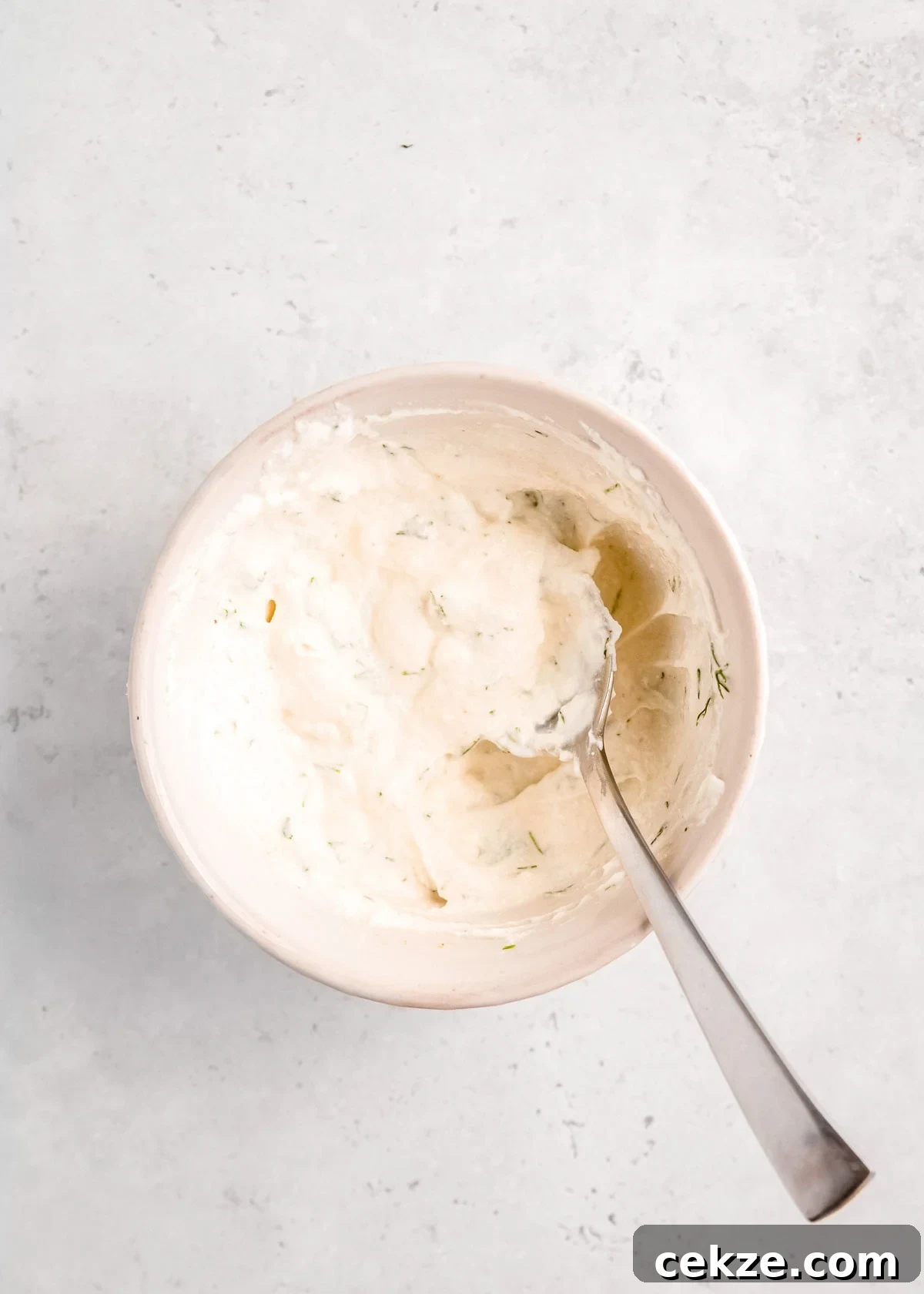 yogurt sauce after being mixed in white bowl