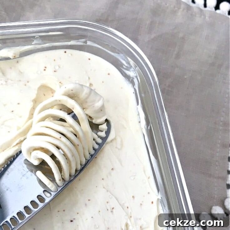 vegan butter in a square glass container, a butter knife spreading a dollop of butter across the surface.