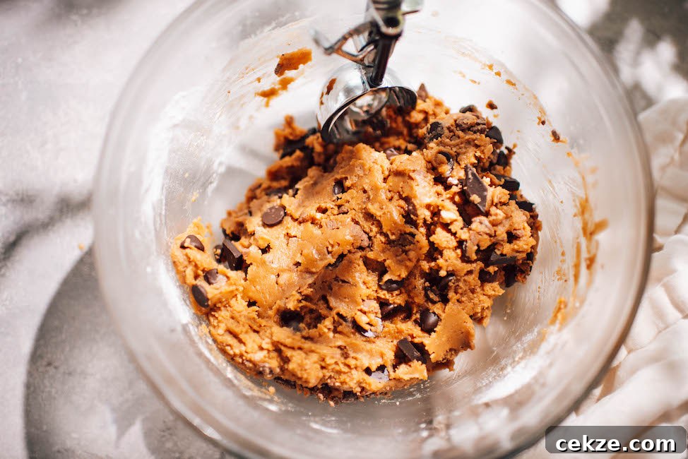 Nutella Toffee and Chocolate Chip Cookies 4 toffee chocolate chip cookie dough in a glass mixing bowl with cookie scoop