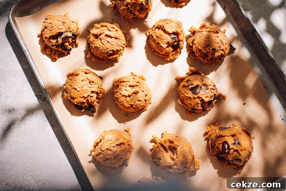 Nutella Toffee and Chocolate Chip Cookies 5 scoops of toffee chocolate chip cookie dough on a parchment lined baking sheet