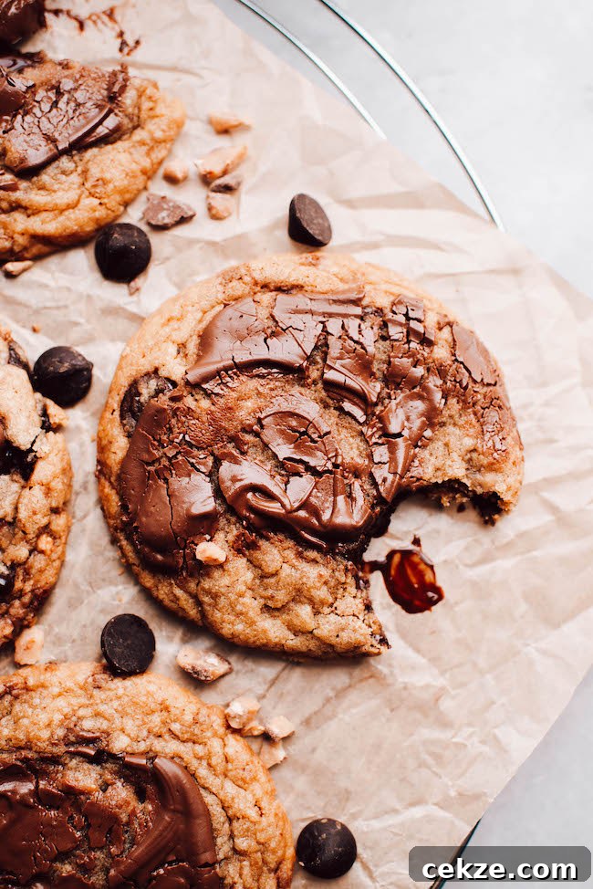 Nutella Toffee and Chocolate Chip Cookies 7 Nutella chocolate chip cookie on parchment paper with bite taken out