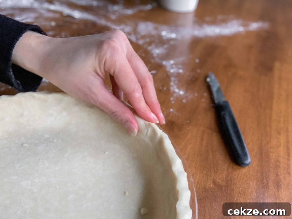 Flaky All-Butter Pie Crust Recipe for Perfect Homemade Pies 6 Crimping the edges of the pie crust