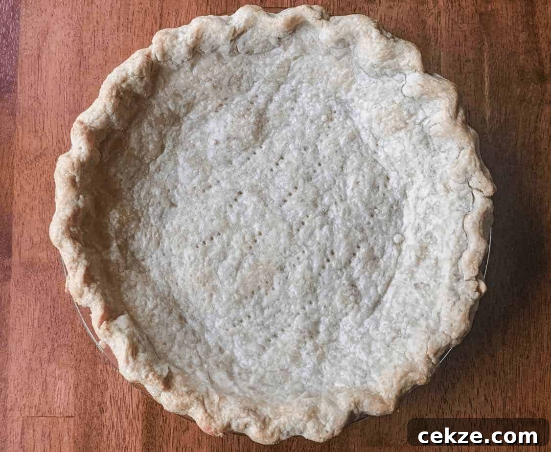 Flaky All-Butter Pie Crust Recipe for Perfect Homemade Pies 9 A prebaked pie crust in a pie dish